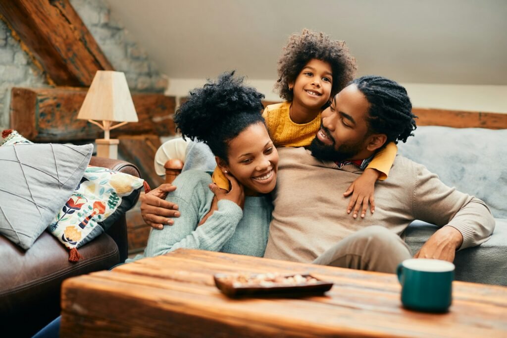 Happy black family enjoying while spending time together at home.